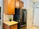 Kitchen with black refrigerator and wood cabinets at 6047 Twin Bridges Dr, Zephyrhills, FL 33541