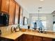 Kitchen with breakfast bar and view into dining area at 6047 Twin Bridges Dr, Zephyrhills, FL 33541