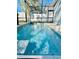 Inviting, refreshing blue swimming pool with cascading water feature at 6047 Twin Bridges Dr, Zephyrhills, FL 33541