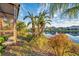 Landscaped backyard with a pond and tropical plants at 613 Tanana Fall Dr, Ruskin, FL 33570
