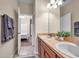 Double vanity bathroom with a view of another bedroom and tiled floors at 613 Tanana Fall Dr, Ruskin, FL 33570