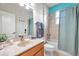 Bathroom with tub shower combo and teal colored walls at 613 Tanana Fall Dr, Ruskin, FL 33570