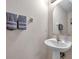 Small bathroom with pedestal sink and mirror at 613 Tanana Fall Dr, Ruskin, FL 33570