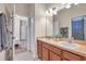 Clean bathroom with dual sinks, a large mirror, and access to a shower at 613 Tanana Fall Dr, Ruskin, FL 33570