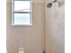 Simple bathroom with a shower and a window for natural light at 613 Tanana Fall Dr, Ruskin, FL 33570