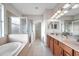 Spacious bathroom with double sinks, garden tub, and walk-in shower at 613 Tanana Fall Dr, Ruskin, FL 33570