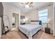 Bright bedroom with a queen-size bed, a home office setup, and access to another room at 613 Tanana Fall Dr, Ruskin, FL 33570
