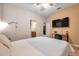 Spacious bedroom with large TV, ensuite bathroom access, and plenty of natural light at 613 Tanana Fall Dr, Ruskin, FL 33570
