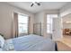 Bright bedroom with a queen bed and access to another room at 613 Tanana Fall Dr, Ruskin, FL 33570