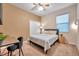 Relaxing bedroom with a full-size bed, a desk, and neutral wall colors at 613 Tanana Fall Dr, Ruskin, FL 33570
