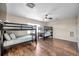 Bedroom with two bunk beds, wood flooring, and ceiling fan at 613 Tanana Fall Dr, Ruskin, FL 33570