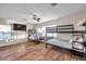Bedroom with three bunk beds, wood flooring, and ceiling fan at 613 Tanana Fall Dr, Ruskin, FL 33570