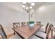 Bright dining room featuring a wood table and chandelier at 613 Tanana Fall Dr, Ruskin, FL 33570