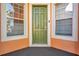 Green front door with sidelights and blinds at 613 Tanana Fall Dr, Ruskin, FL 33570