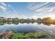 Tranquil lake view with reflections of homes and sunrise at 613 Tanana Fall Dr, Ruskin, FL 33570