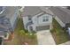 Two-story house with gray roof, driveway, and surrounding houses at 6300 Beverly Hills Dr, Zephyrhills, FL 33541