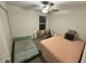 Well-lit bedroom with two beds and ceiling fan at 6300 Beverly Hills Dr, Zephyrhills, FL 33541