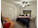 Guest bedroom with a queen bed and ceiling fan at 6300 Beverly Hills Dr, Zephyrhills, FL 33541