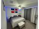 Bright bedroom with a king bed, ottoman, and accent lighting at 6300 Beverly Hills Dr, Zephyrhills, FL 33541