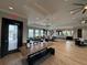 Community room with wooden table, couches and large windows at 6300 Beverly Hills Dr, Zephyrhills, FL 33541