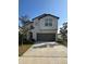 Two-story house with gray garage door and red front door at 6300 Beverly Hills Dr, Zephyrhills, FL 33541