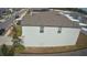 Side view of two story house with gray siding and gray roof at 6300 Beverly Hills Dr, Zephyrhills, FL 33541