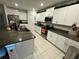 Modern kitchen with granite counters and white cabinets at 6300 Beverly Hills Dr, Zephyrhills, FL 33541