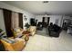 Spacious living room with leather furniture and tile floors at 6300 Beverly Hills Dr, Zephyrhills, FL 33541