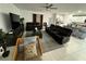 Open living room, leather furniture, and tile floors at 6300 Beverly Hills Dr, Zephyrhills, FL 33541