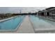 Large community pool with plenty of lounge chairs at 6300 Beverly Hills Dr, Zephyrhills, FL 33541