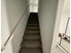 Carpeted staircase leading to the second floor at 6300 Beverly Hills Dr, Zephyrhills, FL 33541