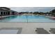 Large community swimming pool with lounge chairs at 6300 Beverly Hills Dr, Zephyrhills, FL 33541