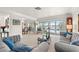 Comfortable living room with lake view and sliding glass doors to the pool area at 7233 15Th Ne Ct, St Petersburg, FL 33702