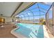 Relaxing screened-in pool and lanai area, featuring scenic lake views, ample seating, and a seamless indoor/outdoor flow at 7233 15Th Ne Ct, St Petersburg, FL 33702