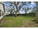 Spacious backyard with large oak trees at 9214 Golf View Dr, New Port Richey, FL 34655