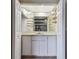 Built-in wet bar with glass shelving and sink at 9214 Golf View Dr, New Port Richey, FL 34655