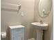 Simple bathroom with pedestal sink and oval mirror at 13621 Willow Bluestar Loop, Riverview, FL 33579