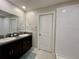 Modern bathroom with double sinks and a separate shower at 13621 Willow Bluestar Loop, Riverview, FL 33579