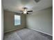 Spacious bedroom featuring a ceiling fan and large window at 13621 Willow Bluestar Loop, Riverview, FL 33579