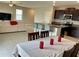 Kitchen and dining area with dark cabinets and granite countertops at 13621 Willow Bluestar Loop, Riverview, FL 33579