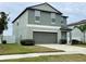 Two story house with green exterior and two car garage at 13621 Willow Bluestar Loop, Riverview, FL 33579