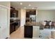 Modern kitchen with dark cabinets, granite counters and island at 13621 Willow Bluestar Loop, Riverview, FL 33579