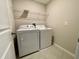 Laundry room with washer, dryer, and overhead shelving at 13621 Willow Bluestar Loop, Riverview, FL 33579