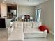 Open living room and kitchen with beige walls and tile floors at 13621 Willow Bluestar Loop, Riverview, FL 33579