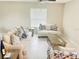 Bright living room featuring beige sofas, a coffee table, and tile floors at 13621 Willow Bluestar Loop, Riverview, FL 33579