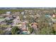 Aerial view of a house with a pool and detached garage; ocean view in background at 13945 75Th Ave, Seminole, FL 33776