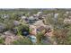 Aerial view of a house with a pool and patio; ocean view in the distance at 13945 75Th Ave, Seminole, FL 33776