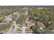 Aerial view of a house with a pool and detached garage, surrounded by lush trees at 13945 75Th Ave, Seminole, FL 33776