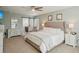 Main bedroom with king-size bed and barn door leading to the ensuite bathroom at 13945 75Th Ave, Seminole, FL 33776