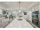 Stylish kitchen features white cabinets, an island, and a view into the living area at 13945 75Th Ave, Seminole, FL 33776
